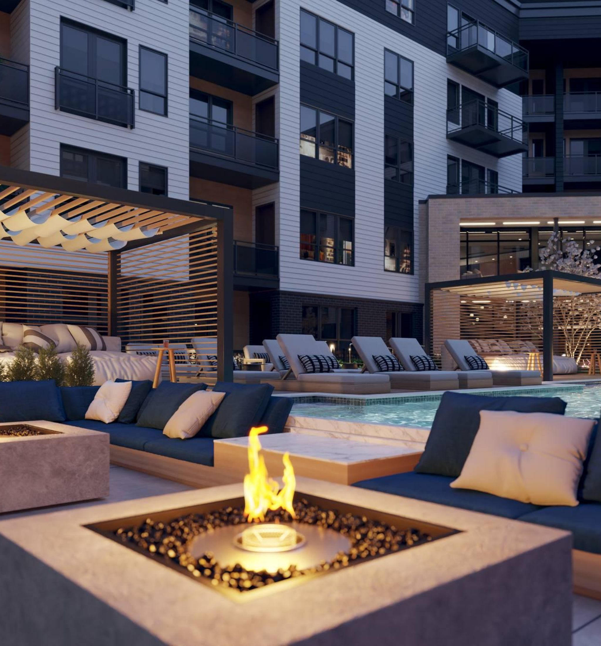 Oberon The inviting pool area of newly constructed city apartments, surrounded by greenery and equipped with comfortable seating.