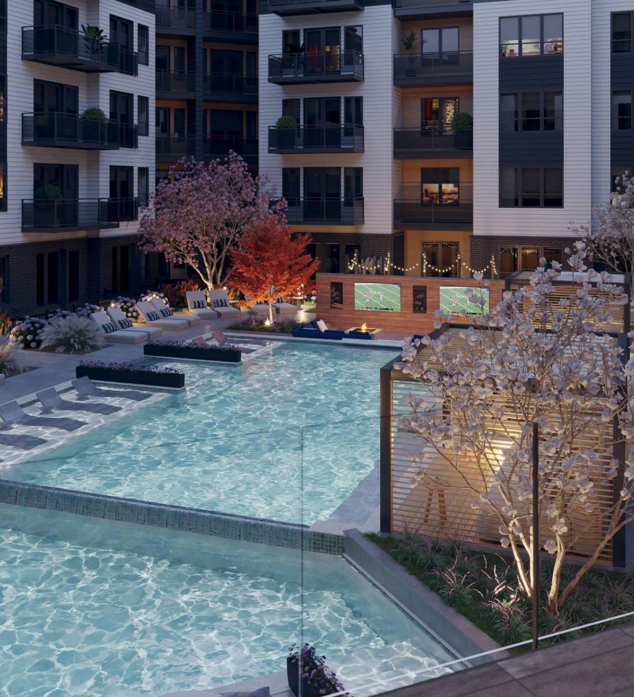 Oberon A serene night view of a pool surrounded by an apartment complex, illuminated by soft lights reflecting on the water's surface.