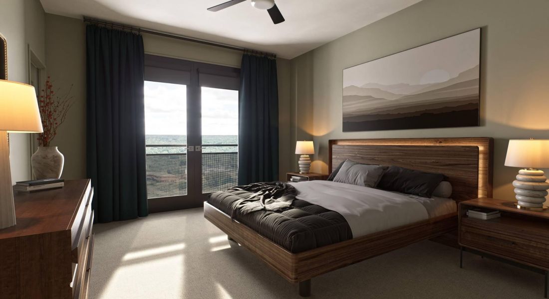 Oberon A cozy bedroom featuring a large bed and a ceiling fan, creating a comfortable and inviting atmosphere.