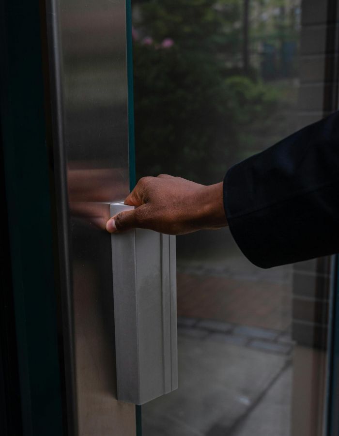 Oberon A person in a suit is poised to open a door, suggesting a moment of transition or opportunity.