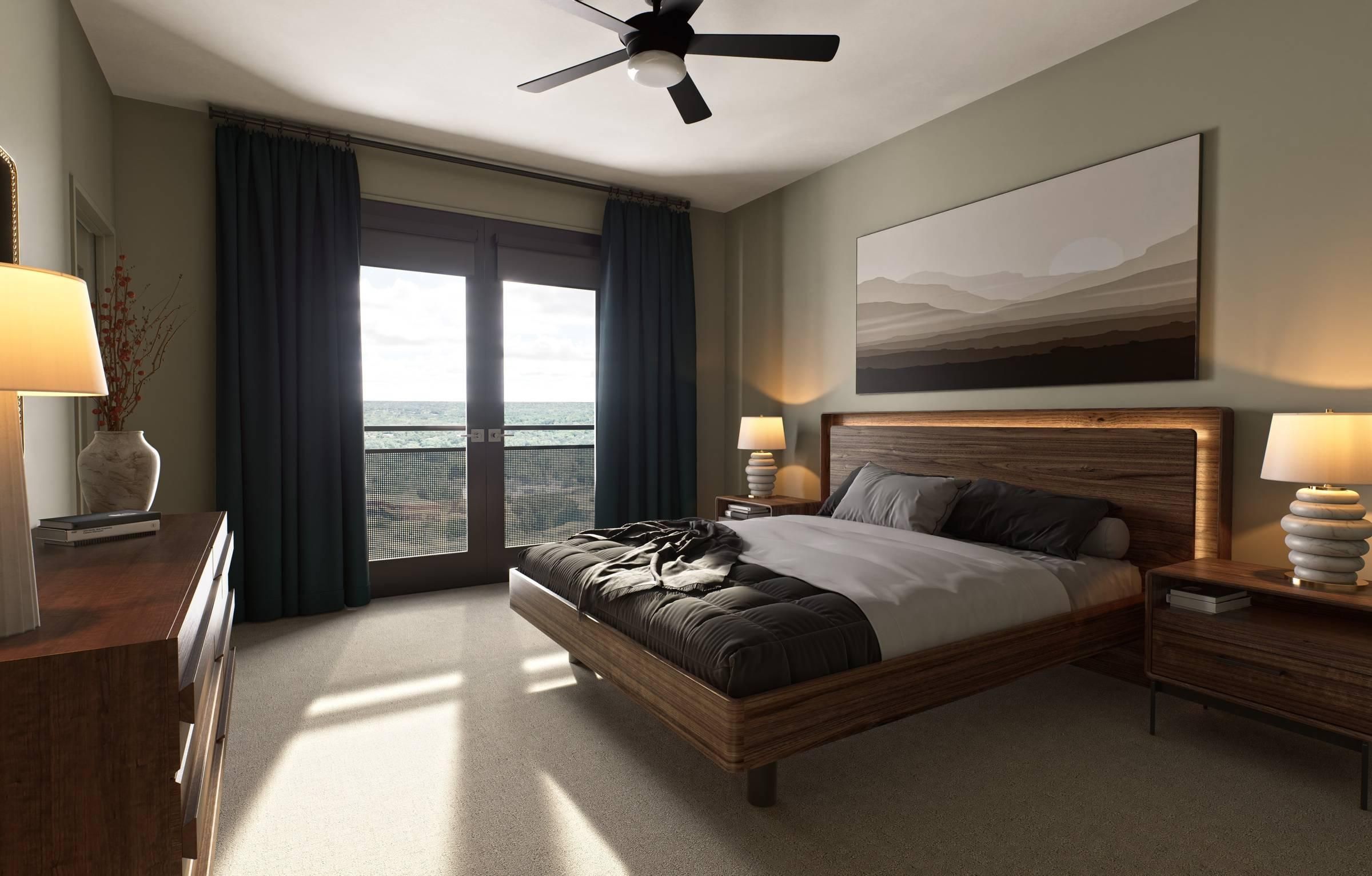 Oberon A cozy bedroom featuring a large bed and a ceiling fan, creating a comfortable and inviting atmosphere.